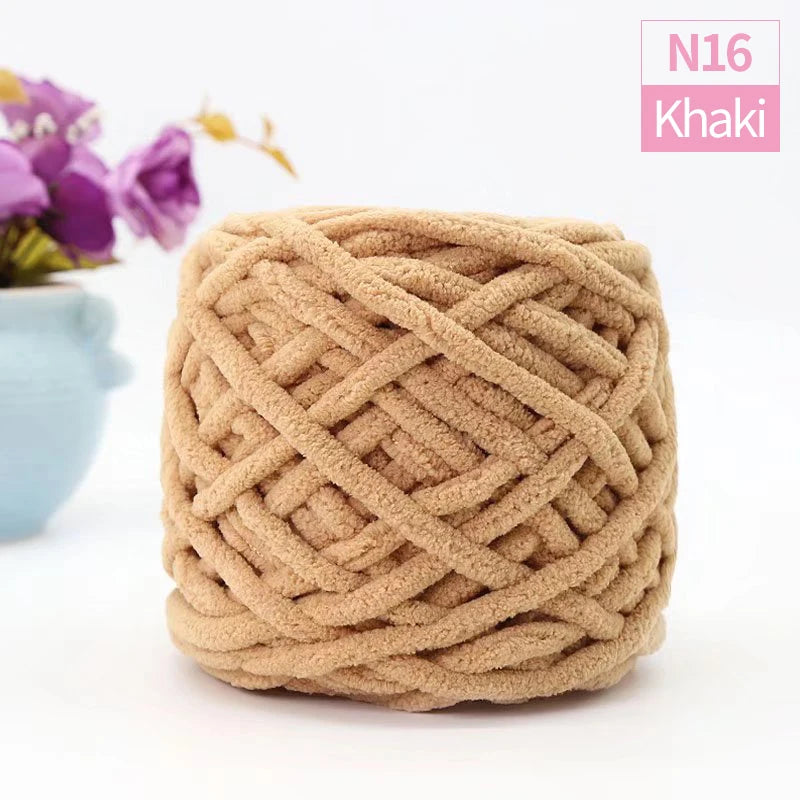 A ball of tan khaki chunky velvet knitting yarn with an intricate woven texture.