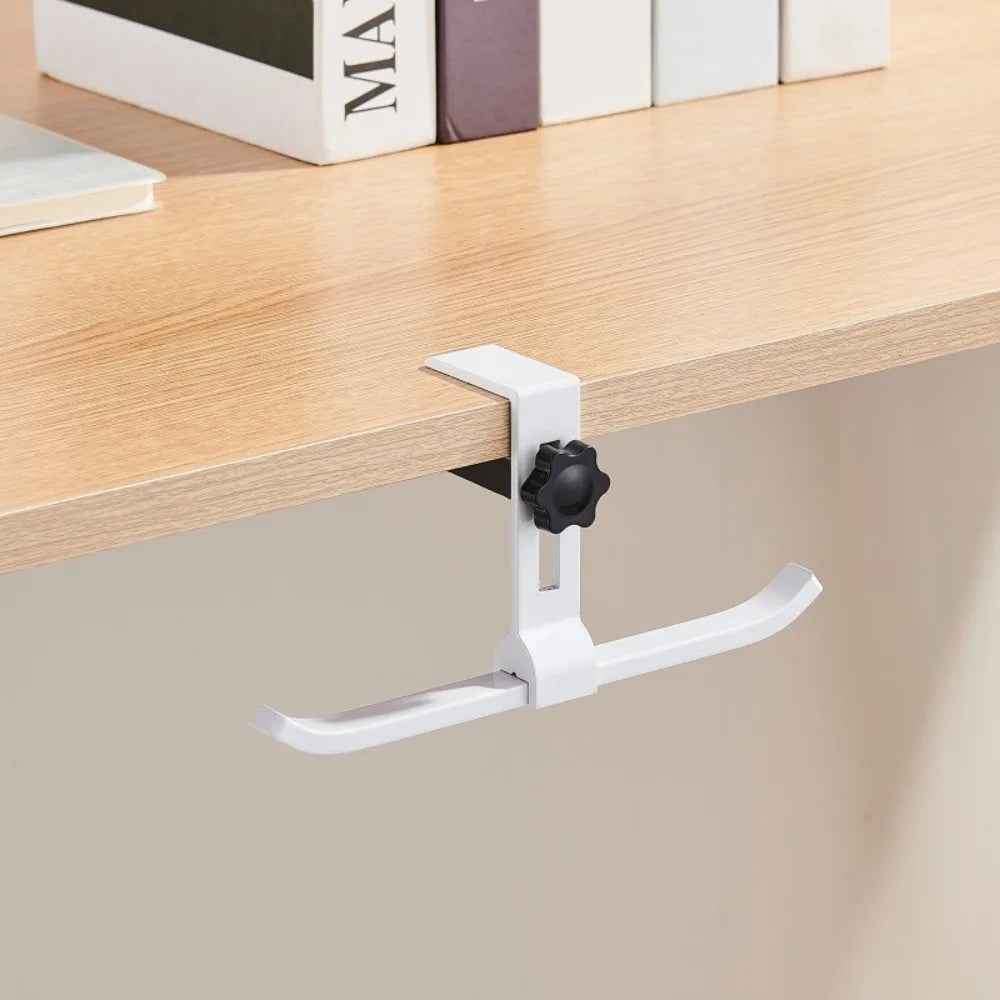 A white adjustable aluminum alloy desk hook with dual clips mounted on a wooden shelf.