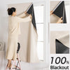 A woman is installing blackout curtains on a window, showing the fabric and installation process.