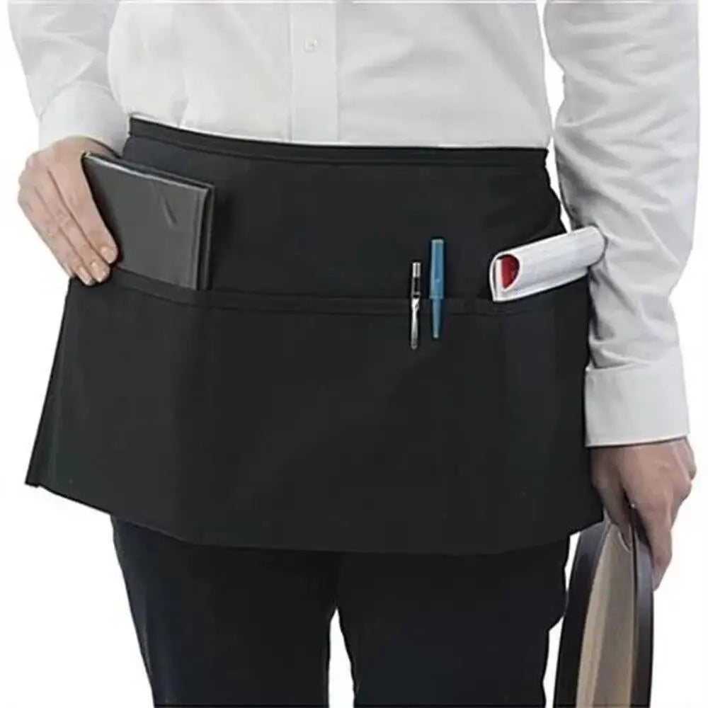 A black unisex waist apron with three pockets worn by a person in a white shirt.