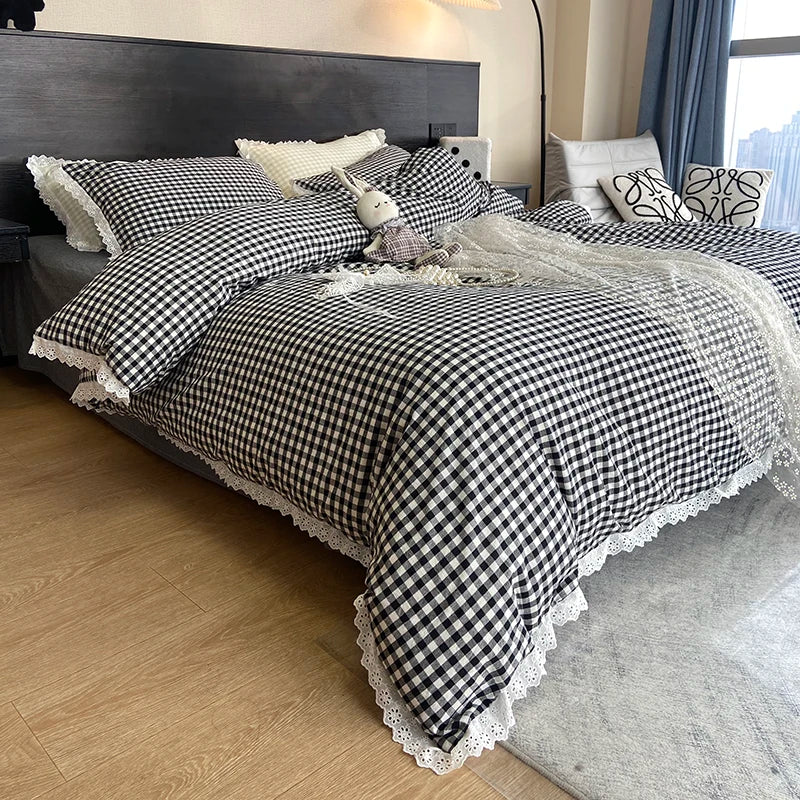 A plaid duvet cover and pillowcase set featuring black and white checkered fabric on a bed.