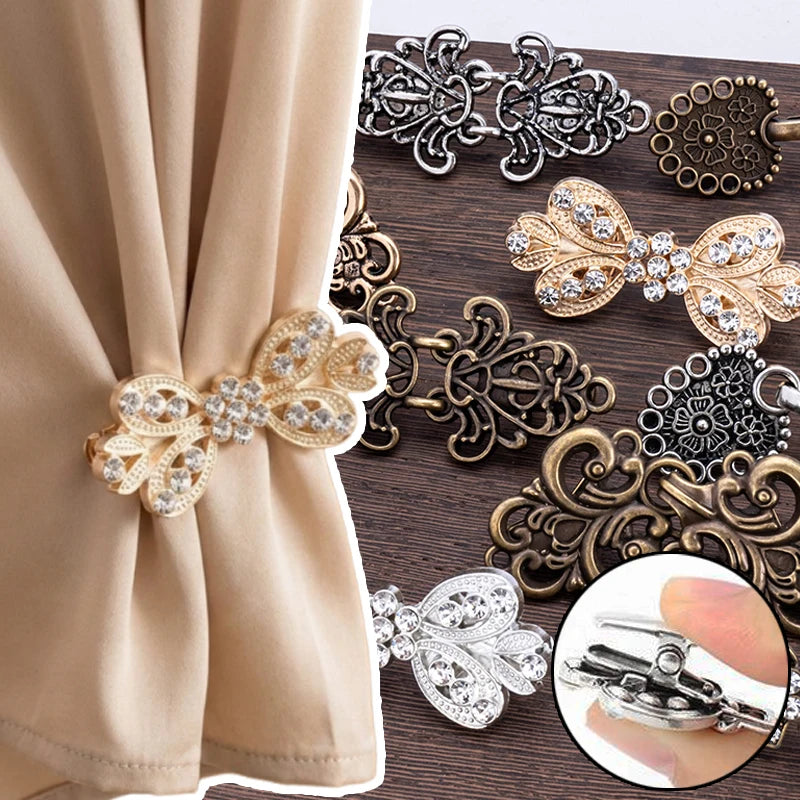 A collection of elegant rhinestone clothing clips and hair accessories in silver and gold tones displayed on a dark wooden su