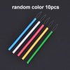Ten random colored needle threaders with metal tips arranged diagonally on a dark background.