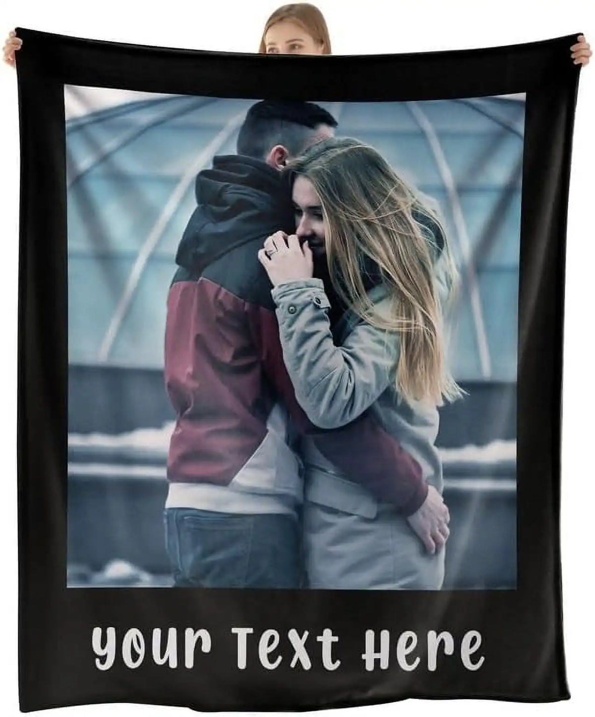 A black throw blanket featuring a photo of a couple embracing in an outdoor setting.