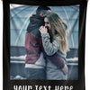 A black throw blanket featuring a photo of a couple embracing in an outdoor setting.