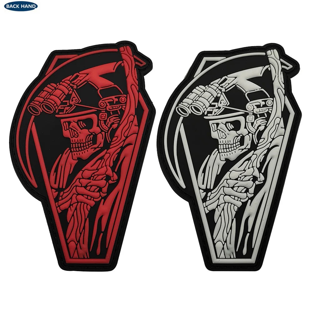 A pair of glow in the dark skull biker patches, featuring a detailed skull design with red and gray linework.