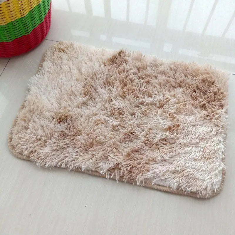 A rectangular beige faux fur rug is displayed on a white surface.