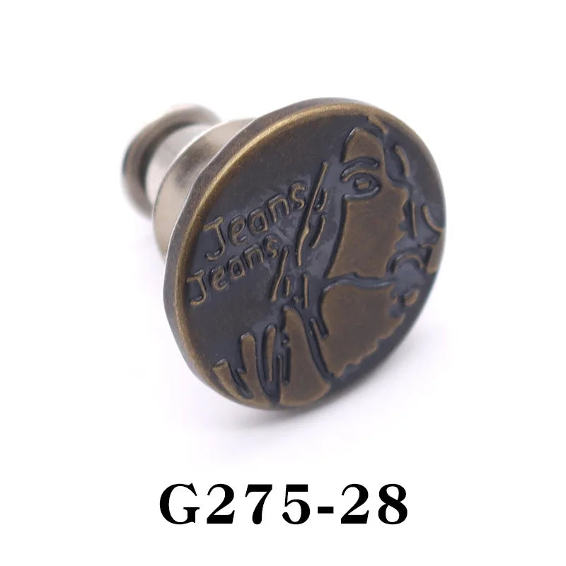 A round, bronze-colored button pin with engraved text reading Jeans Jeans.