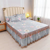 Luxury floral bed skirt in light blue and pink fabric protecting a bed mattress.
