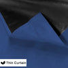 Two panels of royal blue blackout curtains with a black lining shown in a close-up view.