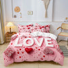 Pink bedding set with red floral pattern and hearts displayed on a bed.