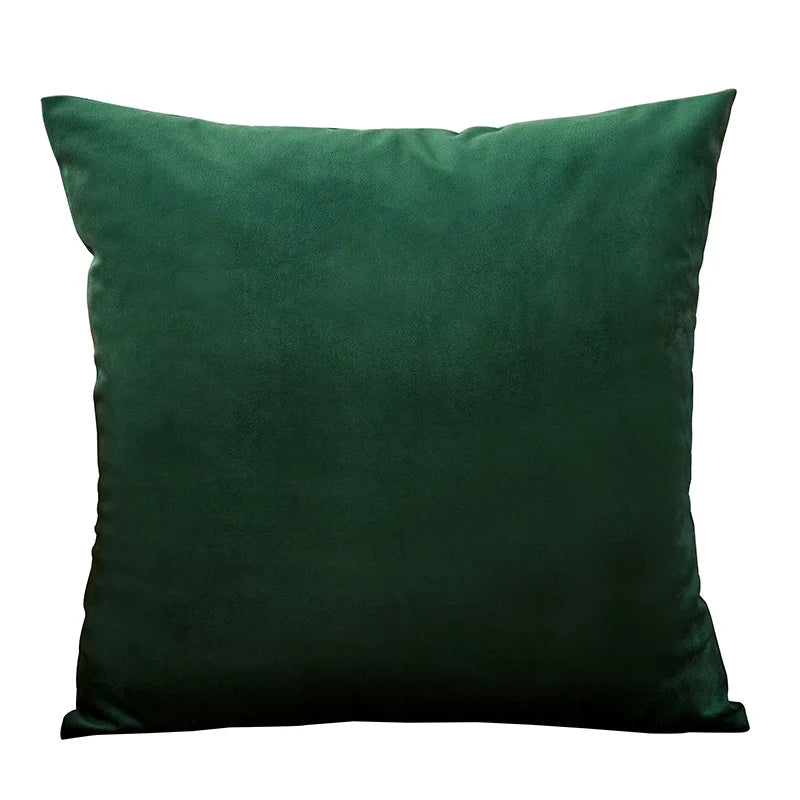 A dark emerald green velvet throw pillow cover.