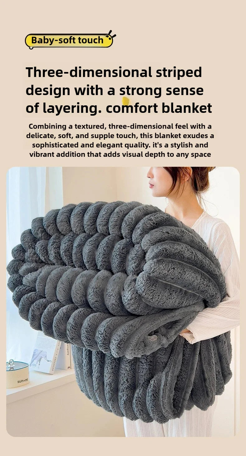 A dark gray, three-dimensional striped blanket is shown draped over a person's arm.