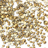 A pile of gold and bronze glass rhinestones for DIY crafts
