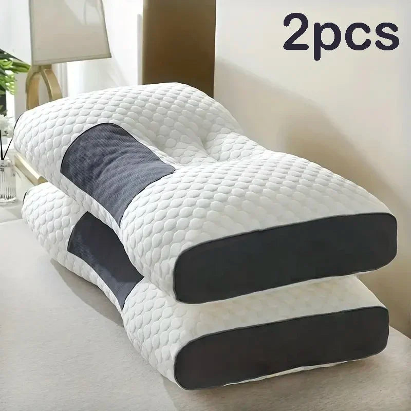 Two white quilted massage neck pillows with dark gray accents shown on a light surface.