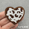 A heart-shaped iron-on patch featuring a brown and white leopard print design.