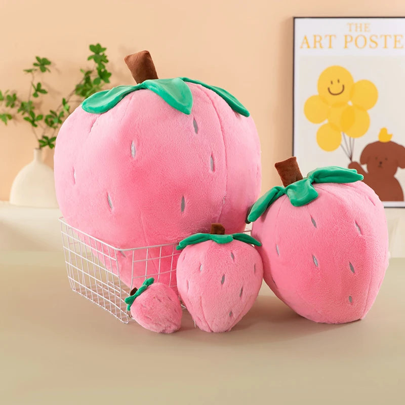 Pink plush strawberry throw pillow with green leaves and brown stem