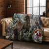 A large fabric throw blanket featuring a collage of various Jurassic Park dinosaurs.