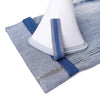 Blue self-adhesive hem tape applied to denim fabric for non-sew repair or shortening.