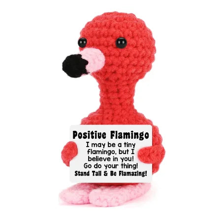 A handmade plush flamingo doll in bright red with a black beak and pink accents.