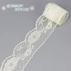 A roll of white decorative lace ribbon, featuring intricate floral patterns and a gathered end.