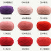 A collection of red and pink knitting yarns shown in various colors and textures.