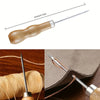A wooden sewing kit with a metal needle and wax thread is shown next to a roll of twine and a piece of leather.