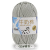 A ball of gray milk cotton yarn with a label in Chinese and English indicating the fiber type and stretch.