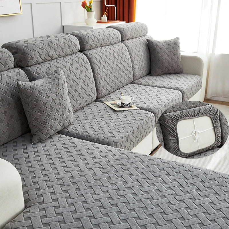 Gray jacquard plush sofa cushion covers arranged on a sofa and a matching floor cover.