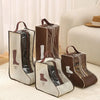 Brown boot storage bags with clear windows and carry handles displayed on a light rug.