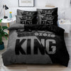 A grey and black king size duvet cover set featuring a repeating king graphic design.