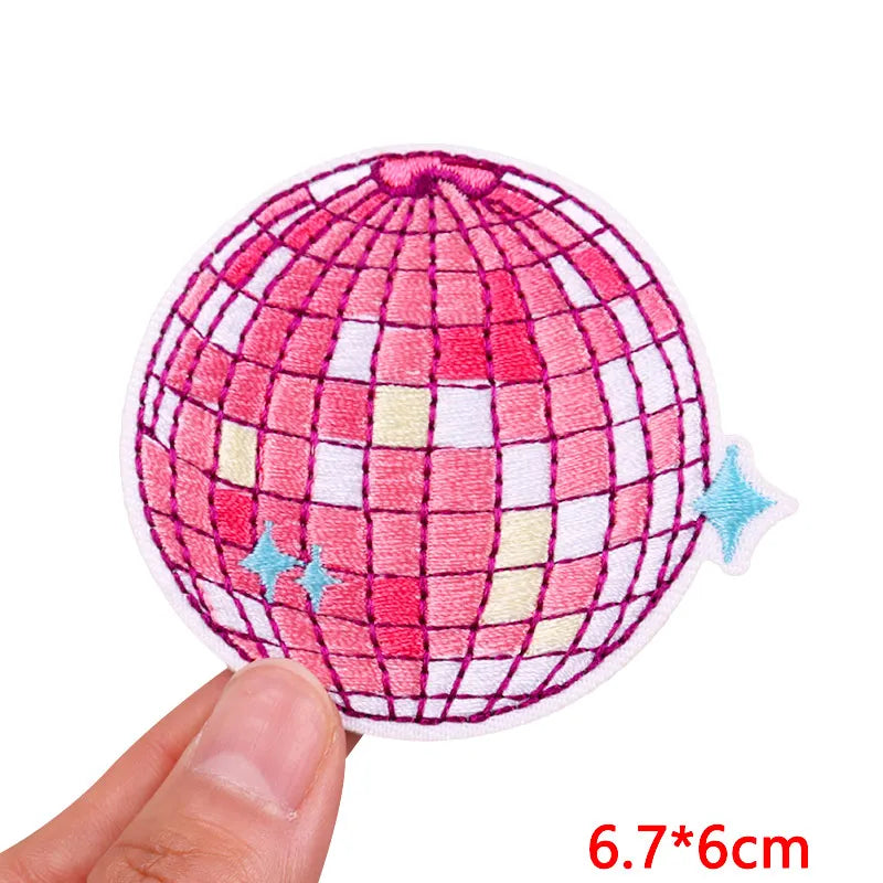 Pink and white checkered spherical embroidered patch with blue sparkles