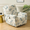 A cream slipcover recliner chair with a blue floral print sits on a wooden floor next to a gold side table.