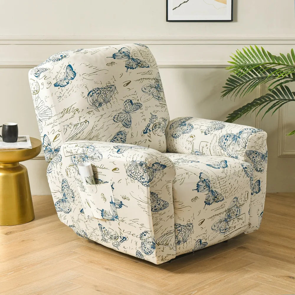 A cream slipcover recliner chair with a blue floral print sits on a wooden floor next to a gold side table.