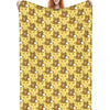 A yellow patterned plush throw blanket featuring cartoon bear designs.