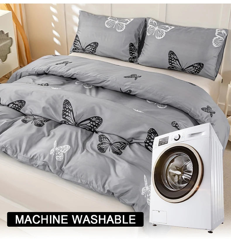 A gray duvet cover with a black butterfly print is displayed next to a white washing machine.