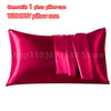 A vibrant magenta satin pillowcase with an envelope closure, shown flat.