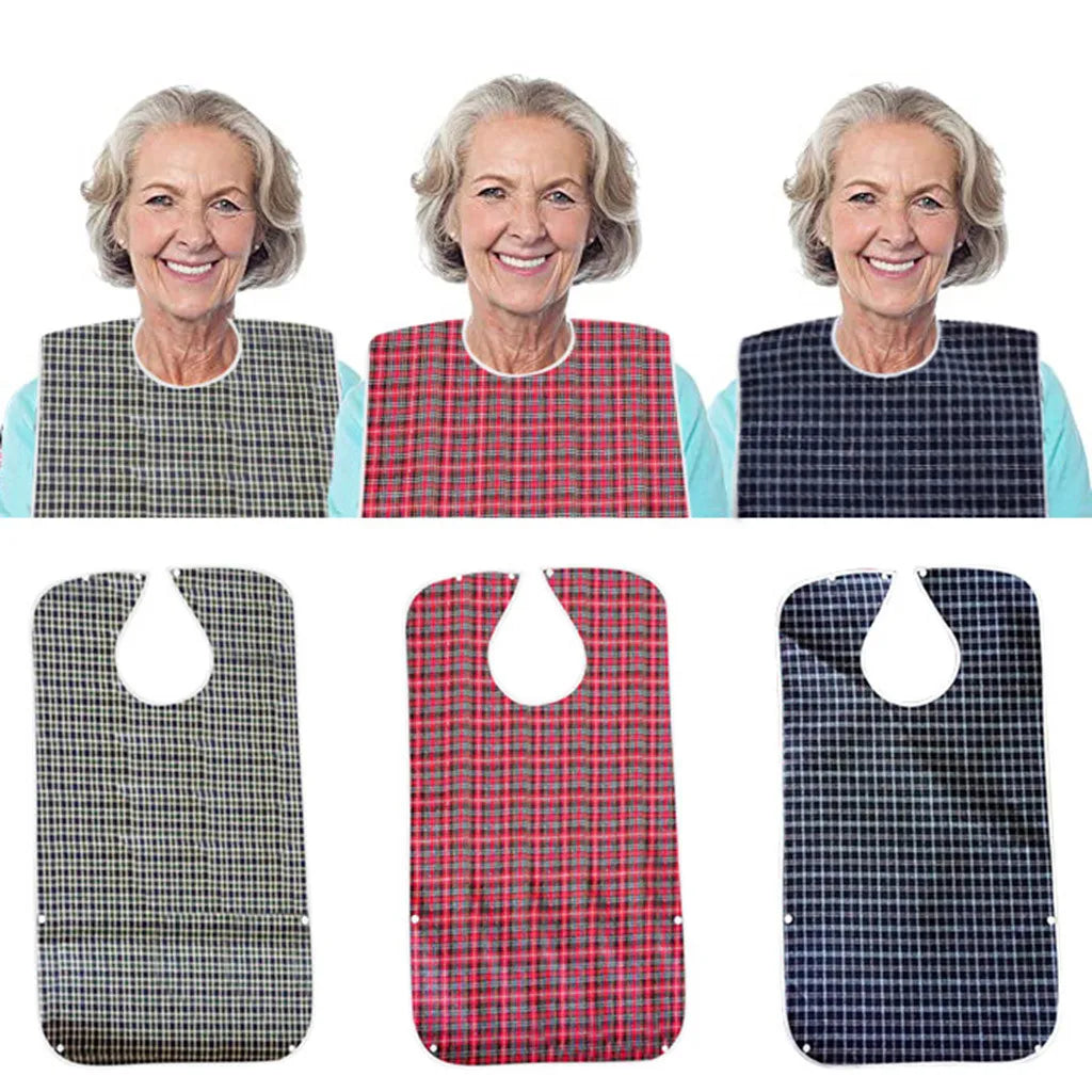 Three elderly women wearing adult waterproof mealtime bibs with adjustable necks and catch-all pockets.