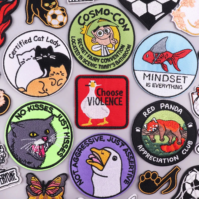 A collection of embroidered cartoon animal patches featuring cats, pandas, and other animals.