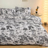 Black and white marble print duvet cover set with pillows displayed on a bed.