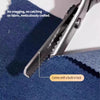 Close-up of stainless steel serrated edge fabric scissors with a built-in lock, shown cutting blue fabric.