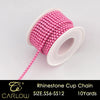 Pink rhinestone cup chain with a long string of beads and a white plastic cap