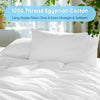 White Egyptian cotton pillow and bedding set with green foliage in the background
