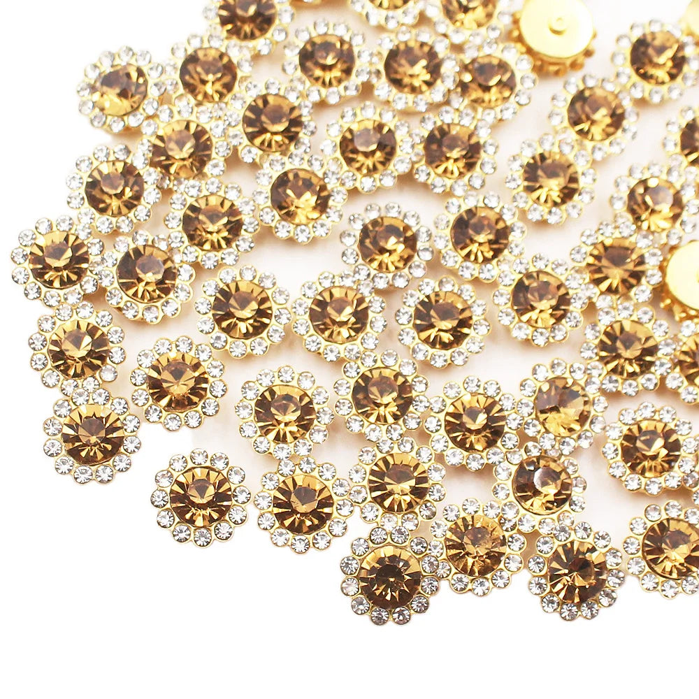 A close-up of sunflower crystal rhinestone sew-on buttons in gold and clear tones.