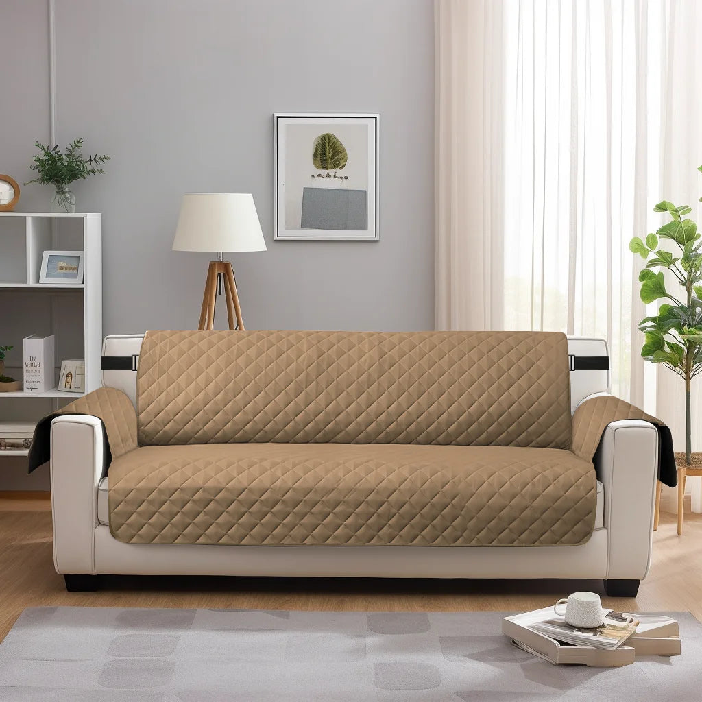 A beige waterproof anti-slip sofa slipcover placed on a light gray floor in a modern living room.