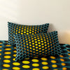 A dark teal duvet cover set featuring a repeating yellow polka dot pattern.