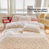 A pink bow printed duvet cover set displayed on a bed with white pillows and light-colored bedding.