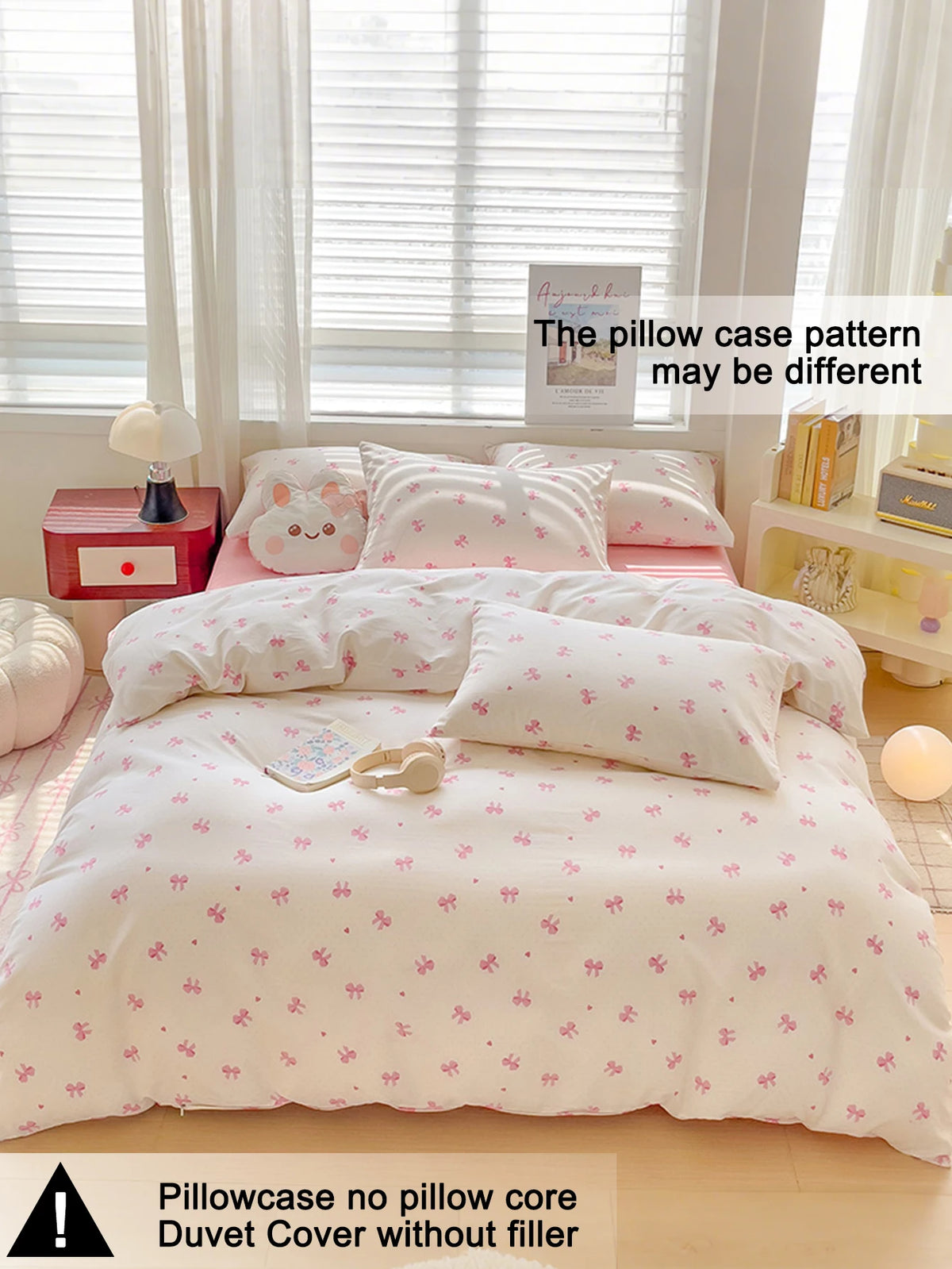 A pink bow printed duvet cover set displayed on a bed with white pillows and light-colored bedding.