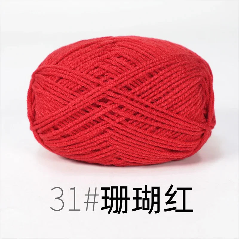 A ball of bright red organic cotton 4ply knitting yarn for crafts.