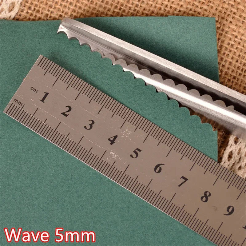 Stainless steel pinking shears shown next to a ruler measuring 9 cm.